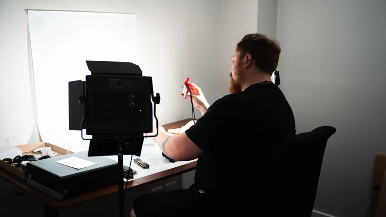 Staff member working at the equipment inspection and product photography setup in our warehouse
