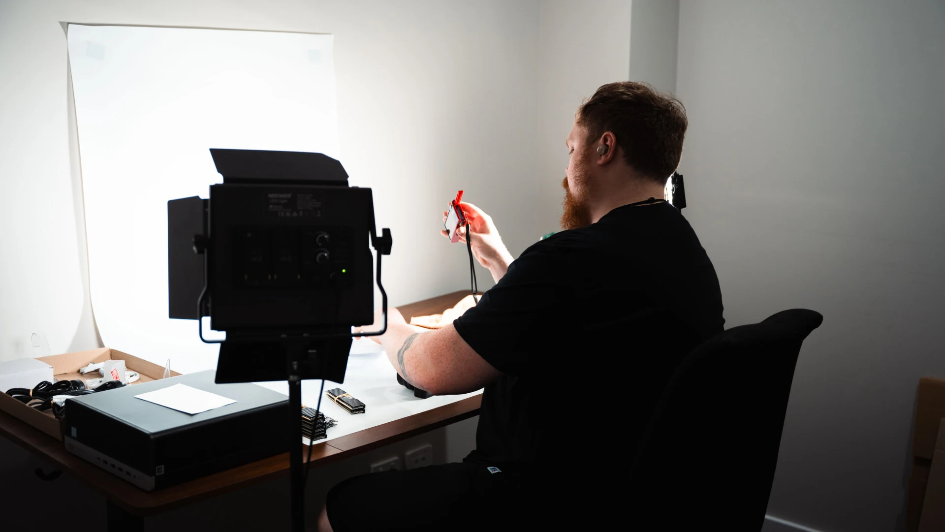 Staff member working at the equipment inspection and product photography setup in our warehouse