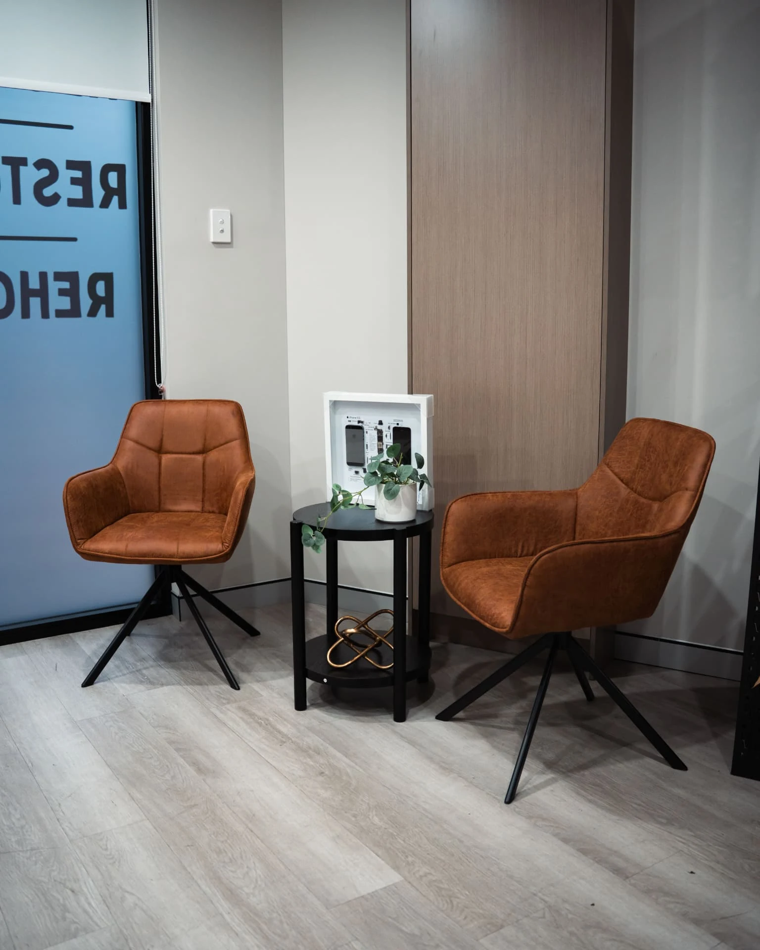 Office seating area with two chairs and a small table at The Recycle Project